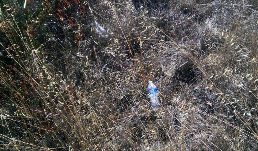 Water bottles litter the trail near Three Sisters Falls.