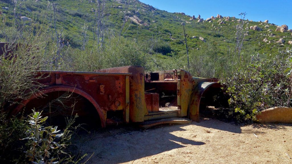 An old, rusty truck lies stranded among the hills on El Cajon Mountain Trail.