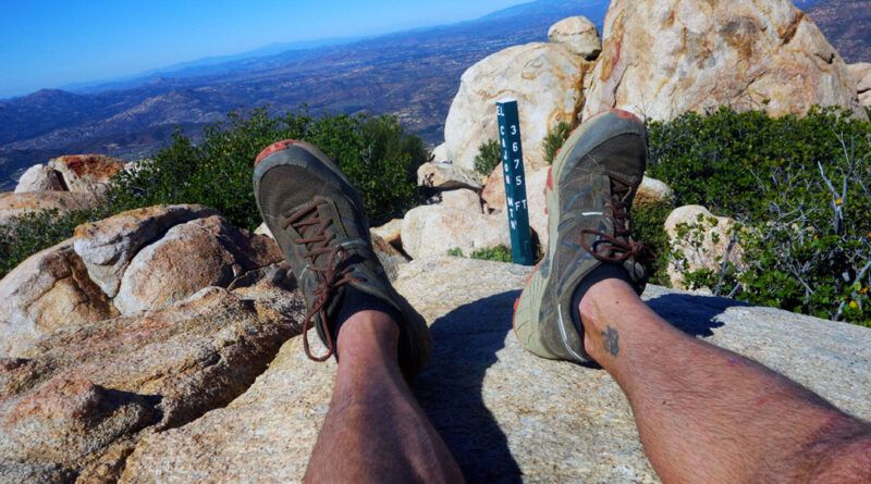 A hiker sits overlooking the valley on the summit of El Cajon Mountain.