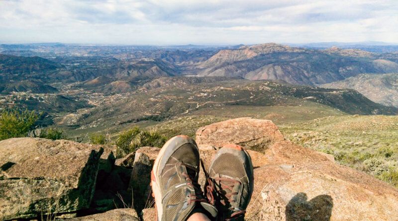 Looking over a hiker's shoes into the valley from the summit of Viejas Mountain trail