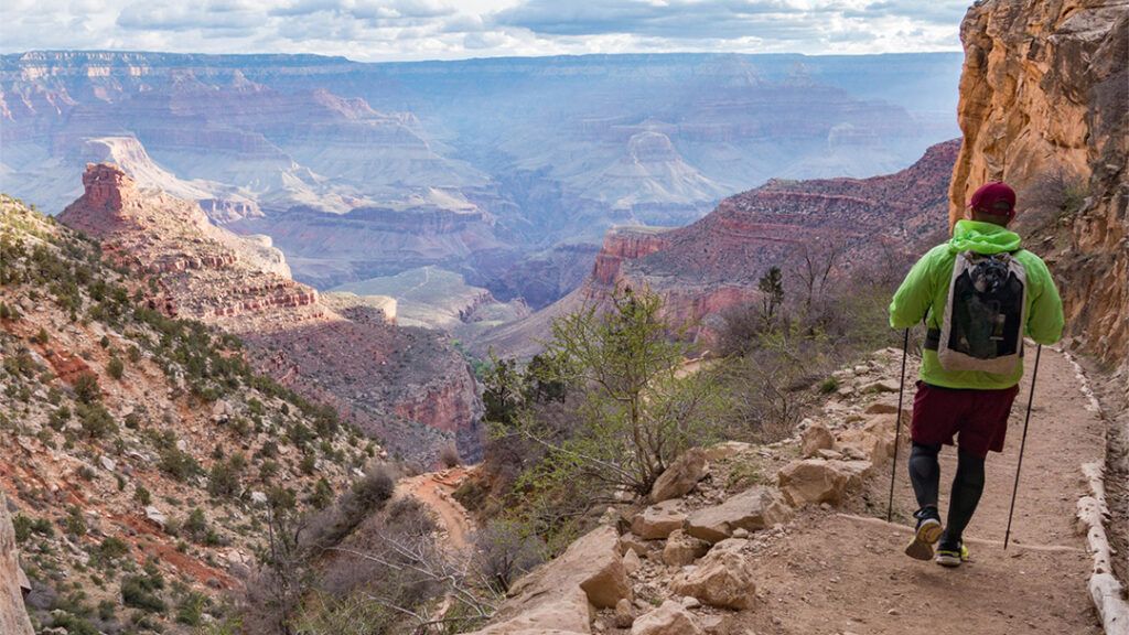 A backpacker hiking into the Grand Canyon on Bright Angel trail.