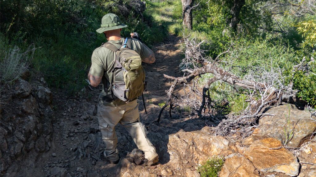 Hiker on a rugged trail in Noble Canyon.