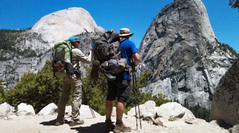 Two backpackers looking at Nevada Falls on the JMT.