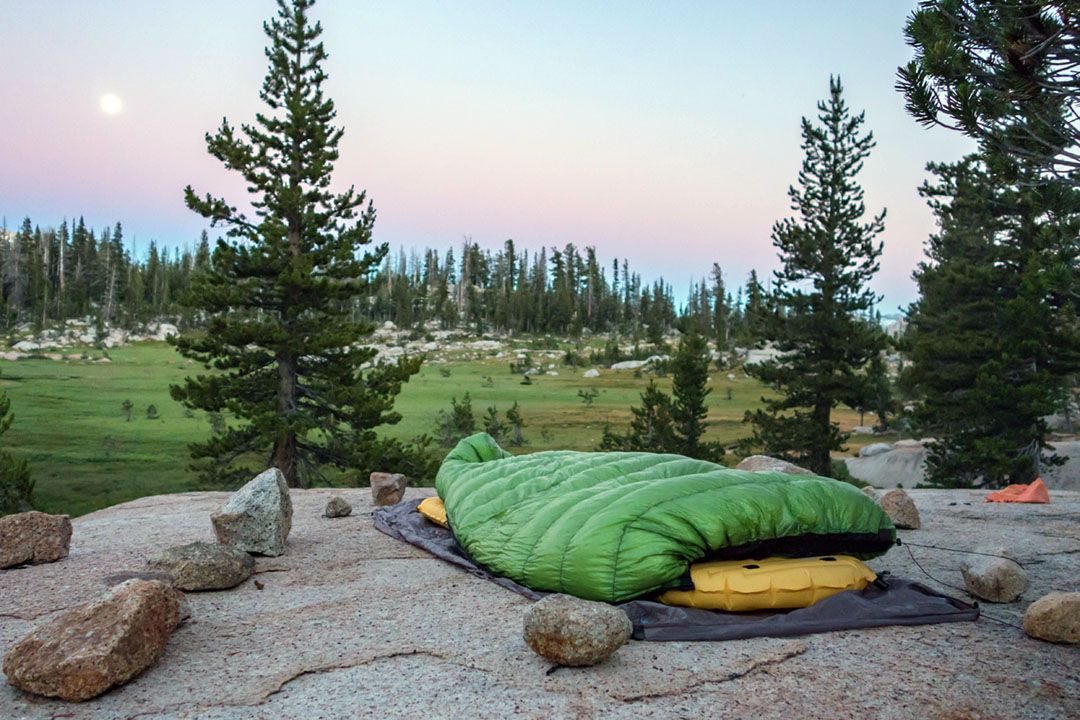 A sleeping bag and pad overlooking Sunrise Lakes meadows.