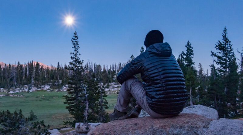 Backpacker watching the moonrise over Sunrise Lakes on the JMT