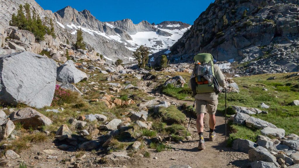 Backpacker hiking towards Donahue Pass on the JMT