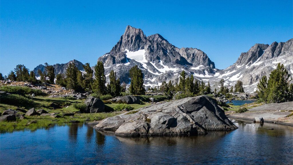 A lake surrounded by rugged mountains at Island Lakes Pass on the JMT
