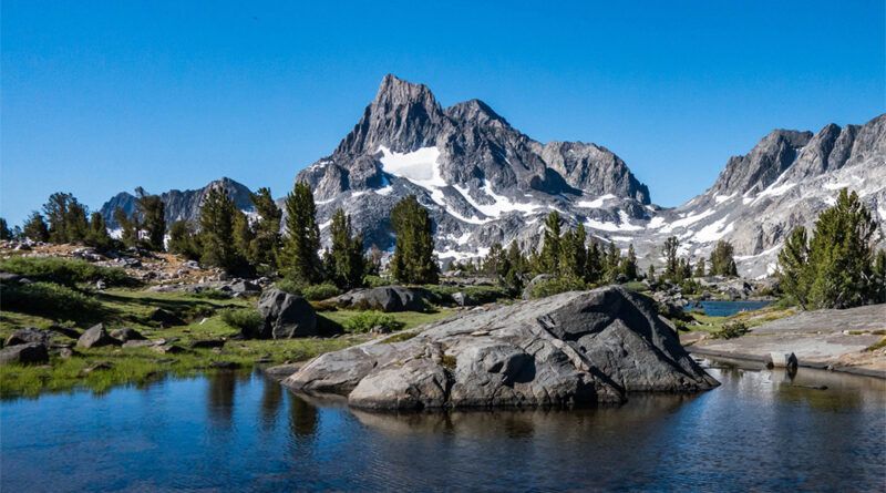 A lake surrounded by rugged mountains at Island Lakes Pass on the JMT