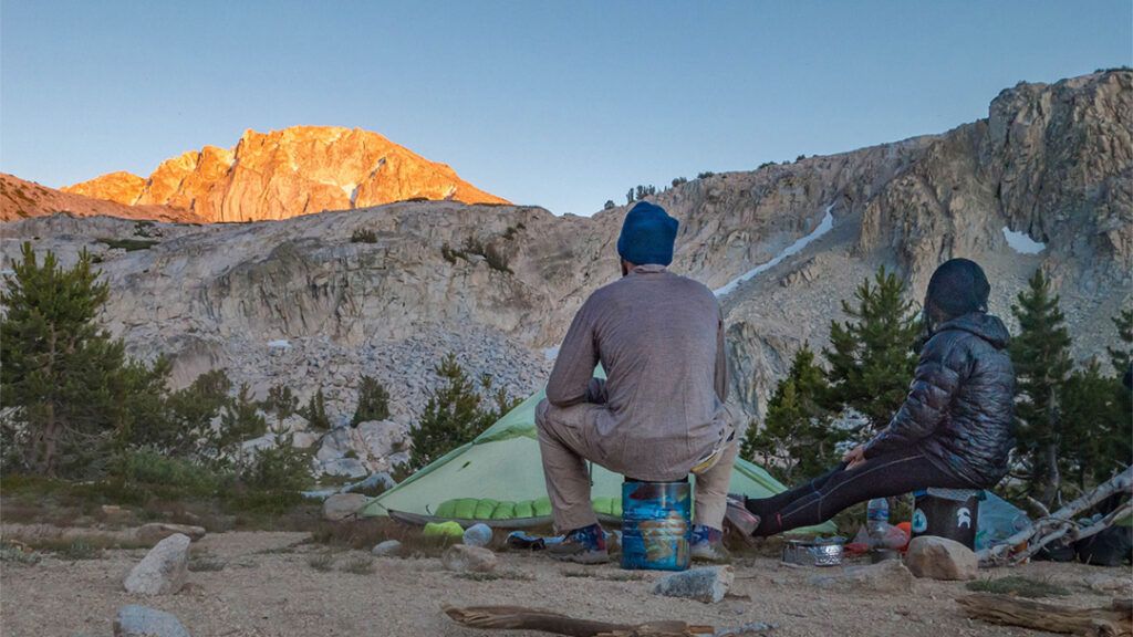 Backpackers watching the sunset on the mountains at Squaw lake